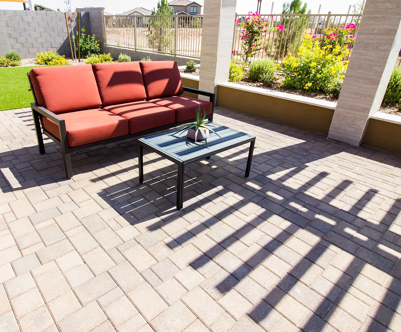 Modern Arizona backyard with large paver patio, built-in fire feature seating area, and layered outdoor living design